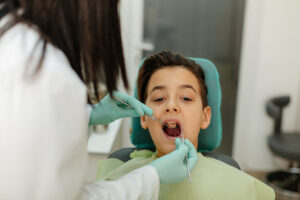 Young boy getting naturally colored tooth fillings in dentist office