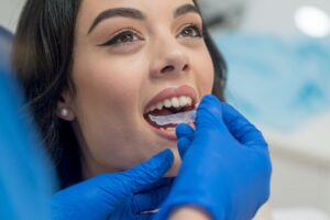 Woman being fitted for mouth guard in dentist office