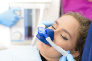 Female patient receiving nitrous oxide anesthesia in dentist office