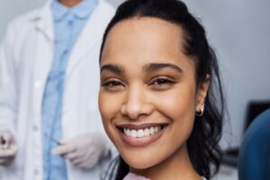 Female patient after receiving teeth whitening treatment at dentist office